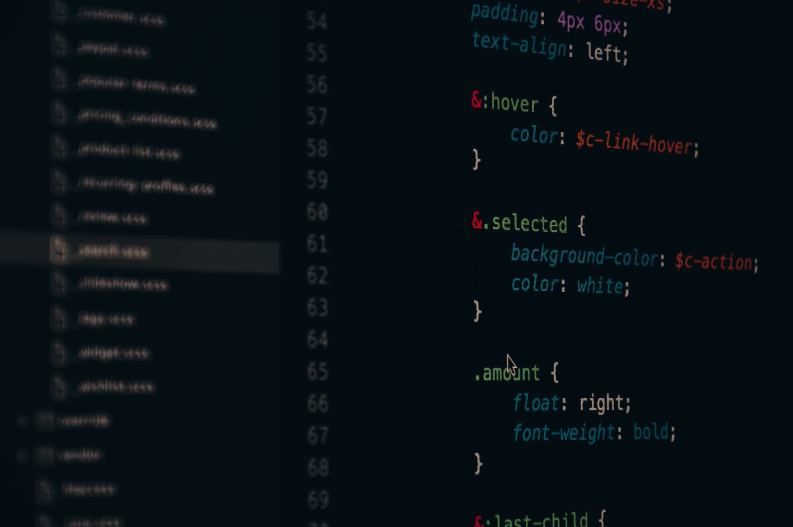 A laptop screen showing CSS source code in a code editor