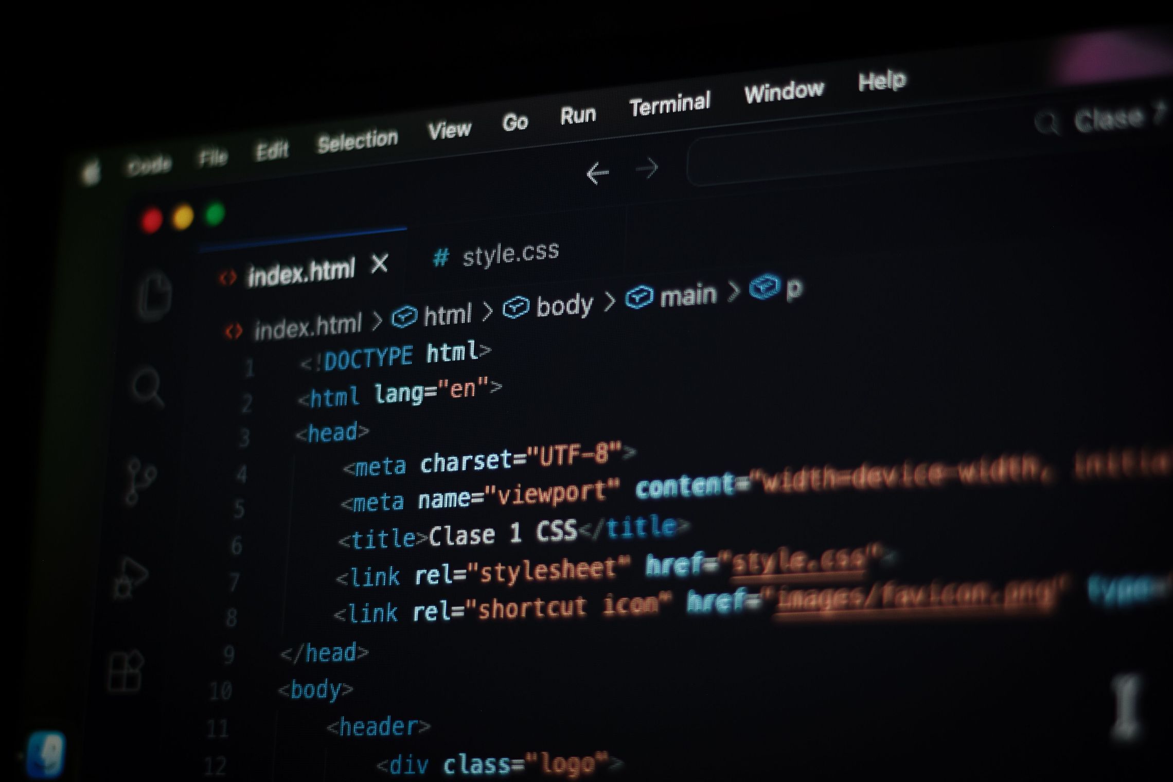 A code editor in dark mode showing an index.html file with the doctype and head tags