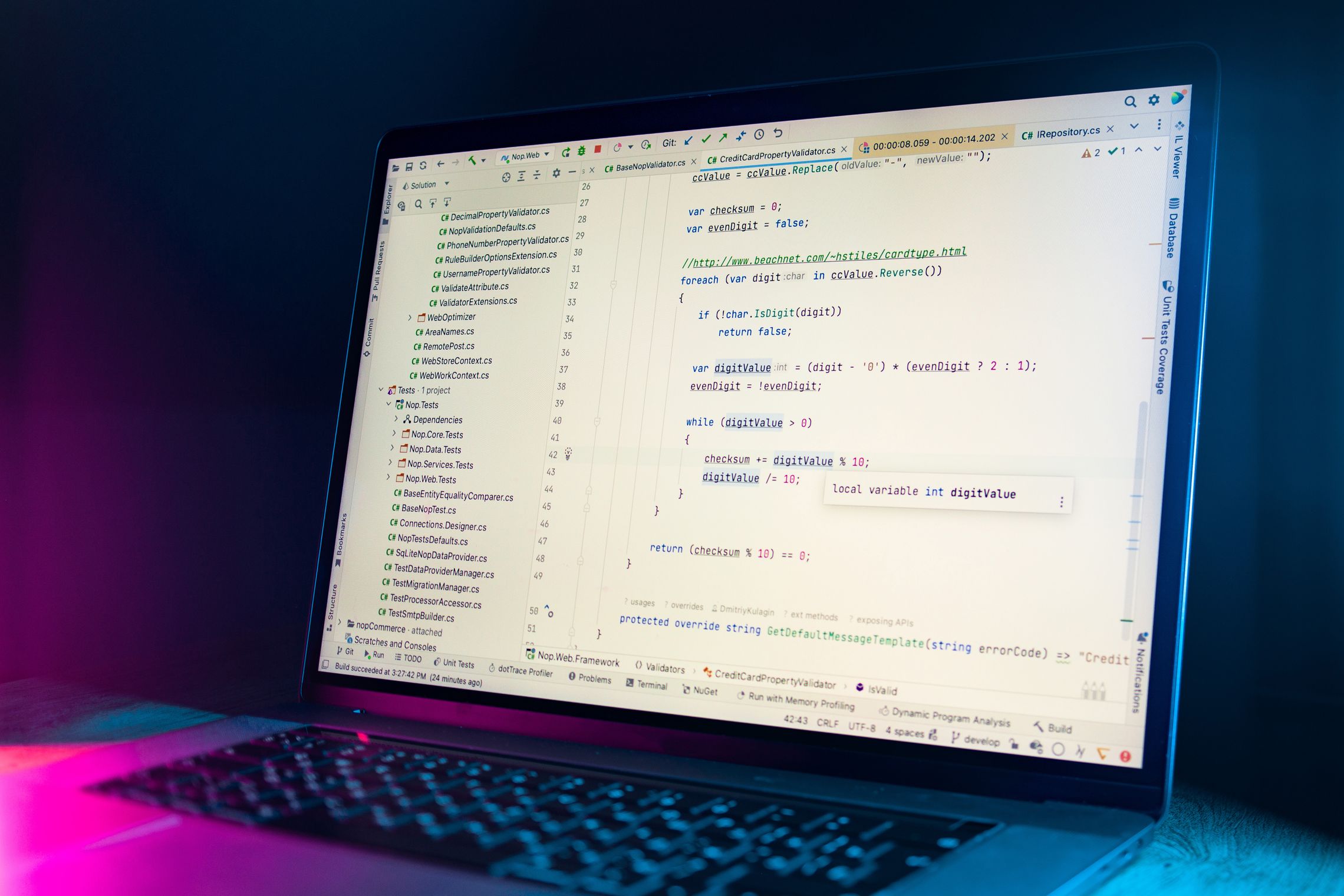 A code editor on a laptop showing an inline tooltip for a variable