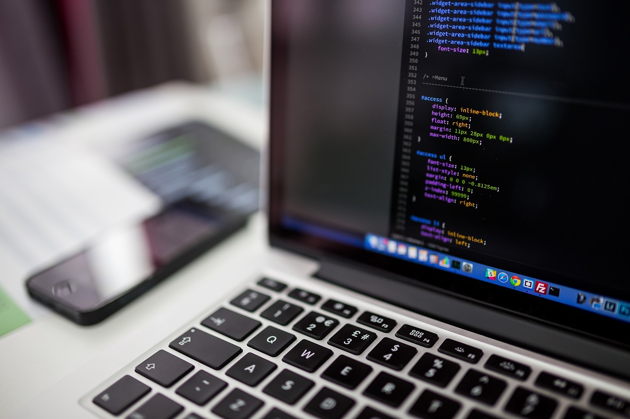 A laptop screen showing CSS source code open in a code editor